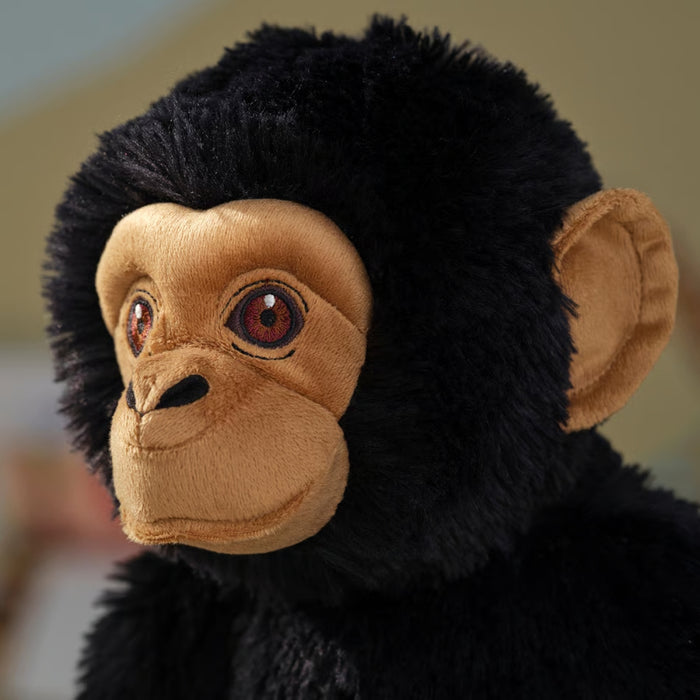 Detailed view of SANDLÖPARE chimpanzee face with embroidered eyes and fuzzy black fur