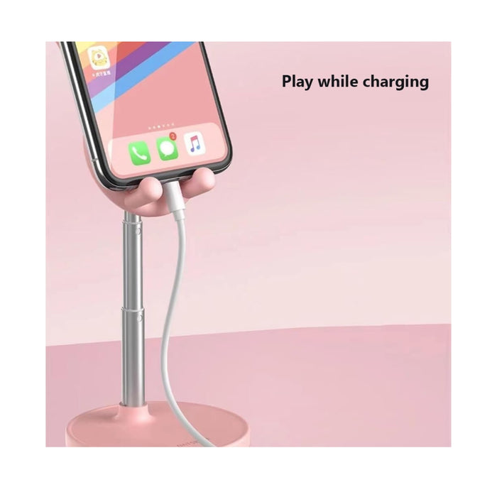 Phone held on a stand with charging cable, pink background