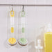 This image showcases two VIDEVECKMAL dish sponge dispensers, one in light green and another in a cheerful yellow, both conveniently hung from a rail on the wall. This design allows for quick drying and easy access. Each dispenser comes with an attached sponge, ready to tackle your dishwashing needs.