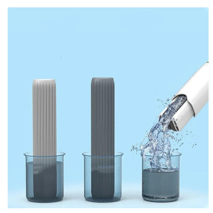 Two cylindrical filters being rinsed with water from a faucet against a blue background