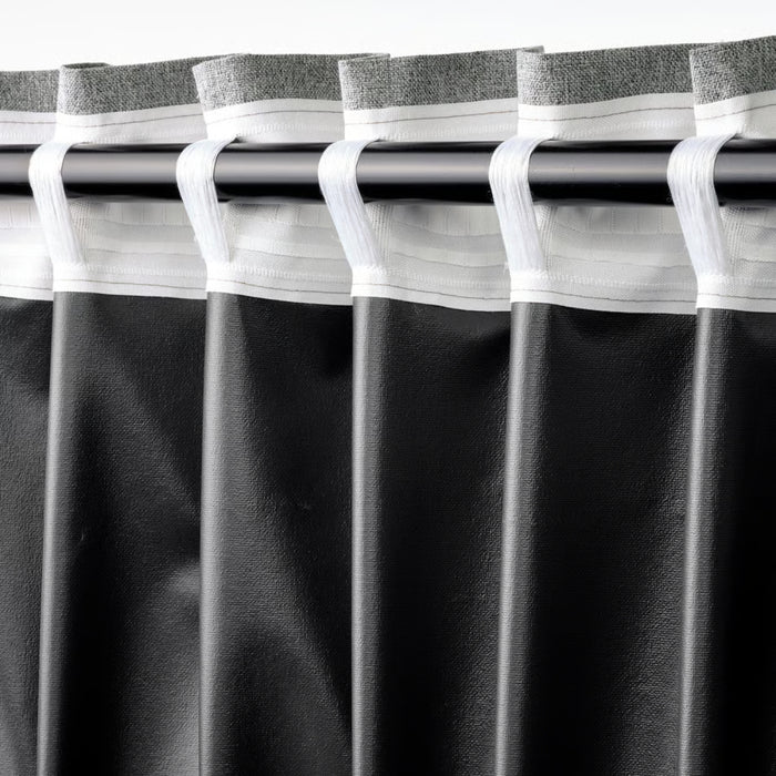 Black curtains with gray trim on a rod against a white background