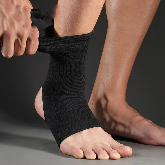 Black ankle sleeve – person pulling up elastic brace over ankle for secure fit and support