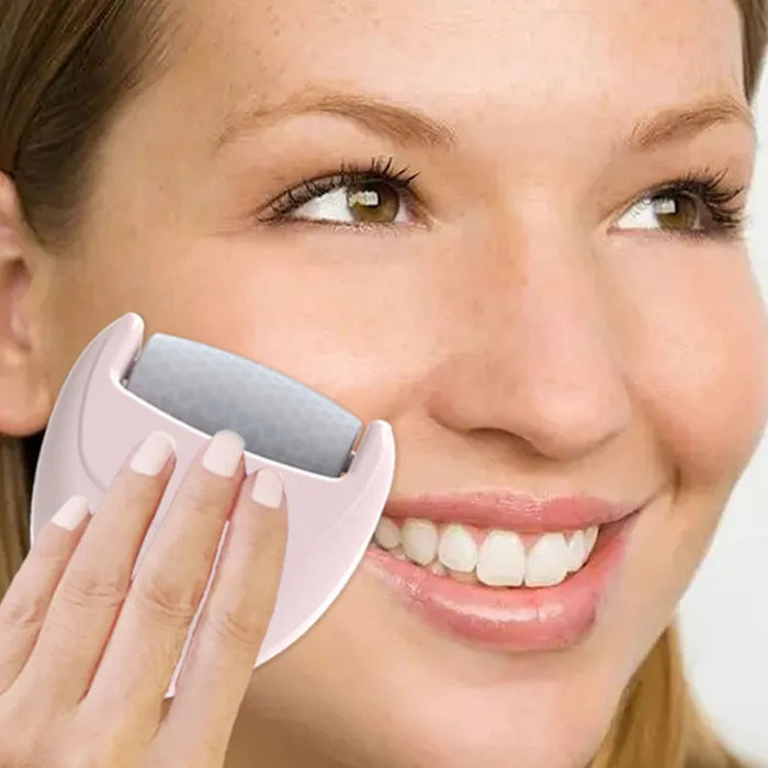 Heart-shaped ice roller – person smiling while using cooling roller on cheek for skincare and facial massage