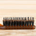 Hairbrush with bristles on a wooden background