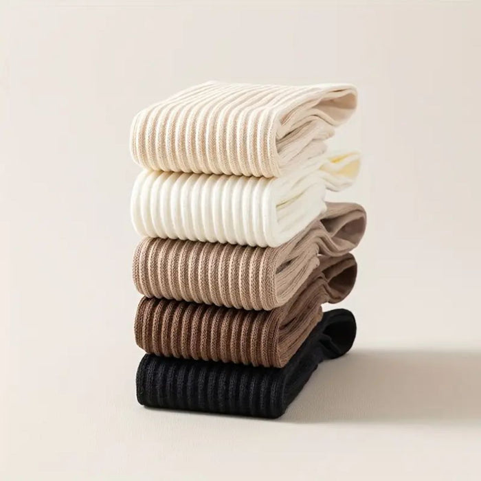 Stack of five folded ribbed socks in cream, white, light brown, medium brown, and black
