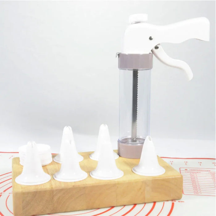 Baking tool with wooden holder and white nozzles on a light gray background