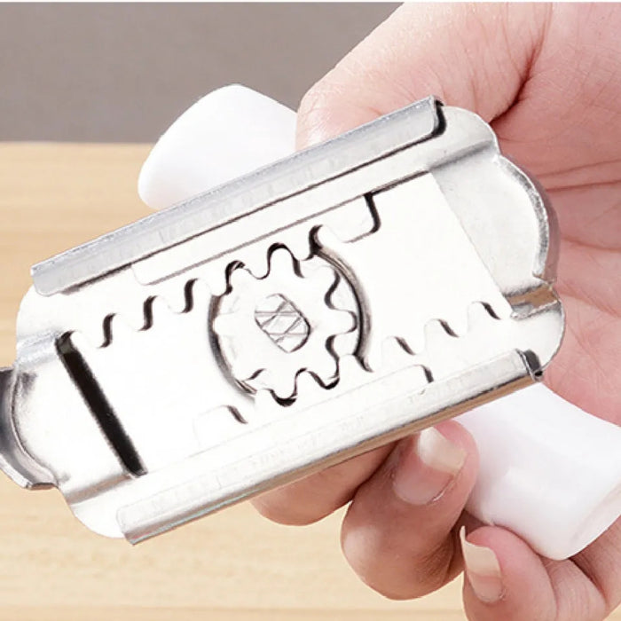 Metallic stamp held in a hand with a plain background