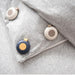 Three round heating pads on a gray textured surface