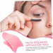 Woman applying false eyelashes with an applicator tool on a white background