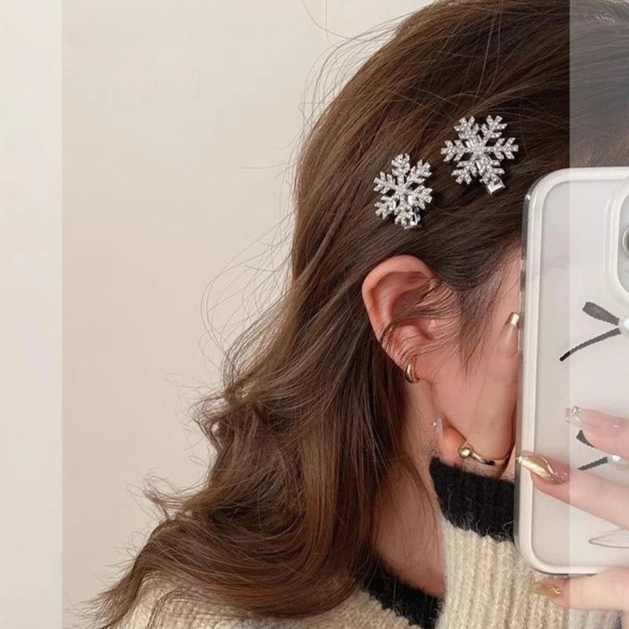 Crystal snowflake hairpins – two clips above ear with gold earrings and ribbon phone case