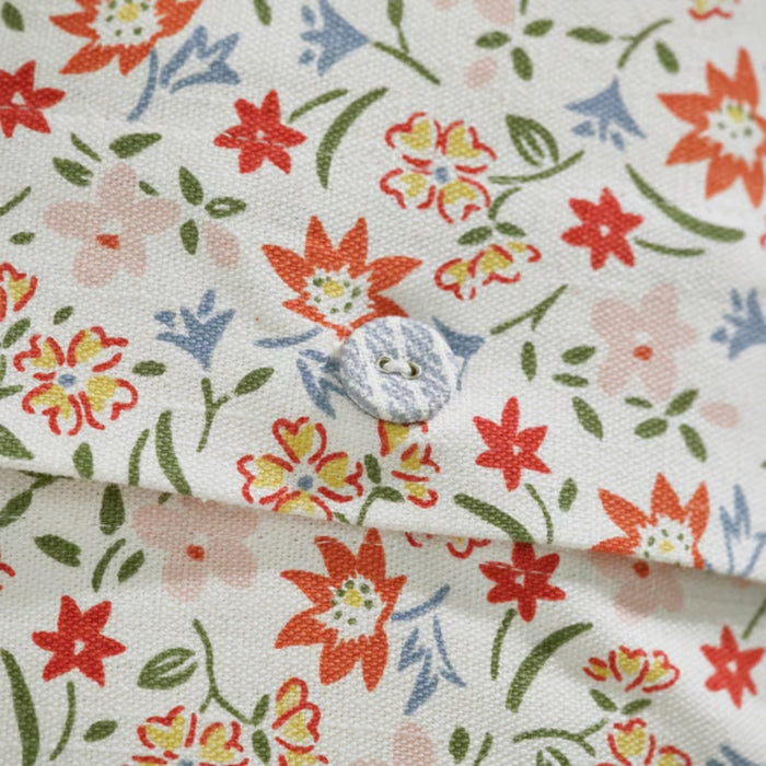 GULLNATTLJUS cushion cover, white/floral, 50x50 cm. Features multicolour flowers and fabric-covered button on white cotton – vibrant and elegant accent piece – 90598702.
