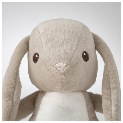 Plush toy rabbit with long ears on a light gray background