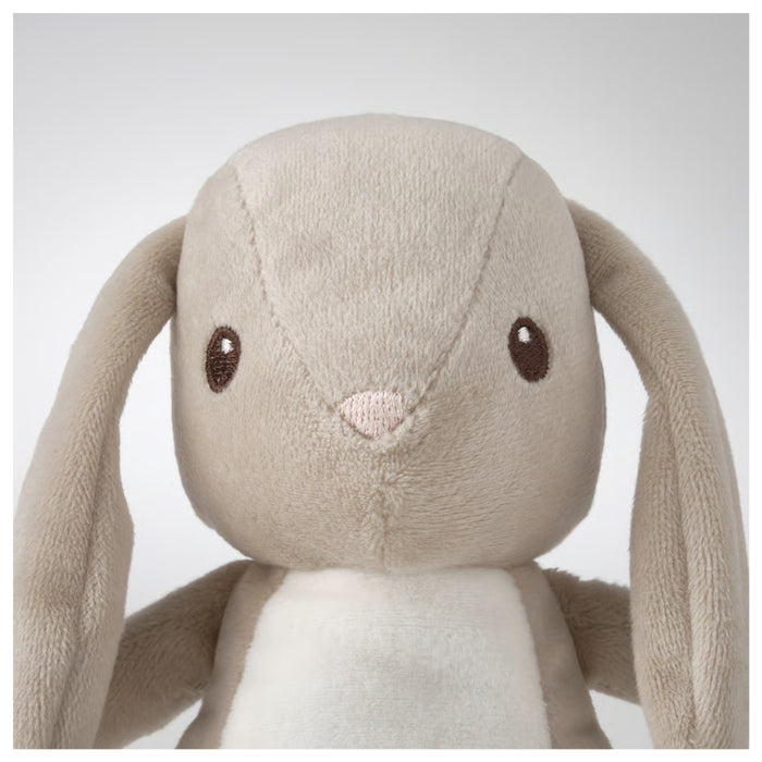 Plush toy rabbit with long ears on a light gray background