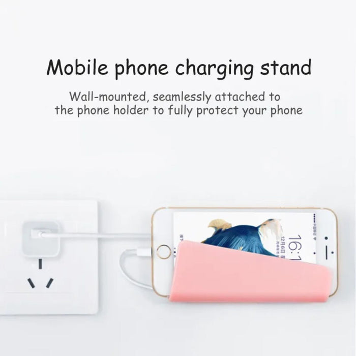 Phone charging stand with phone and power adapter on a white background