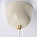 Close-up of the ceiling cup of the RÖDFLIK lamp in light beige with a stylish brass cord fastener.