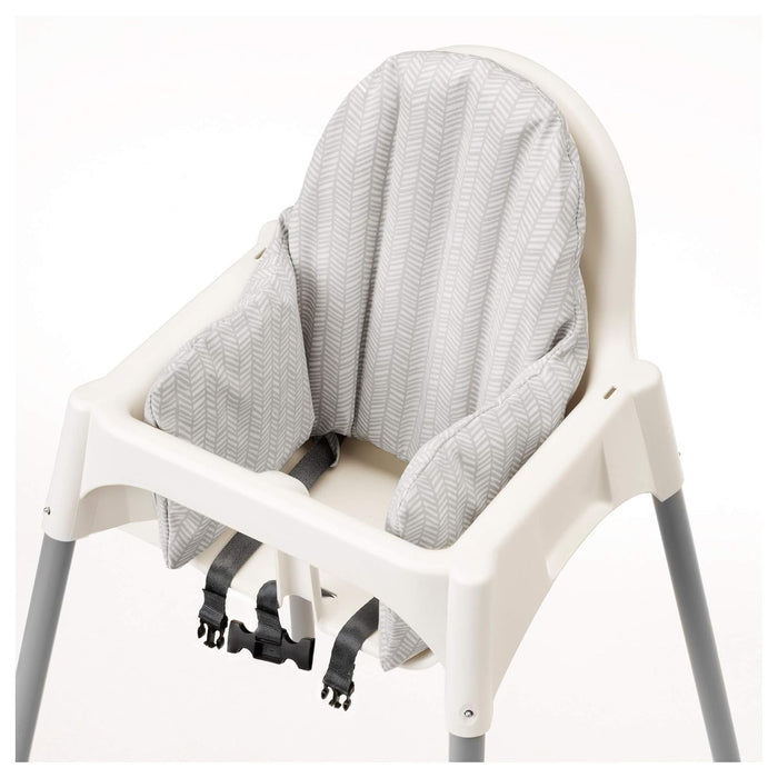 White high chair with a gray textured cover on a white background