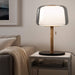 Modern table lamp on a side table in a living room setting