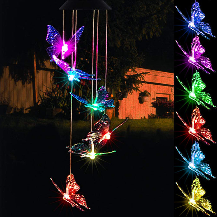 Solar-powered LED wind chime featuring multiple butterfly-shaped lights glowing in vibrant colors—purple, blue, green, red, and yellow—against a nighttime garden backdrop. Adds a decorative and whimsical touch to outdoor spaces like yards, patios, and balconies.
