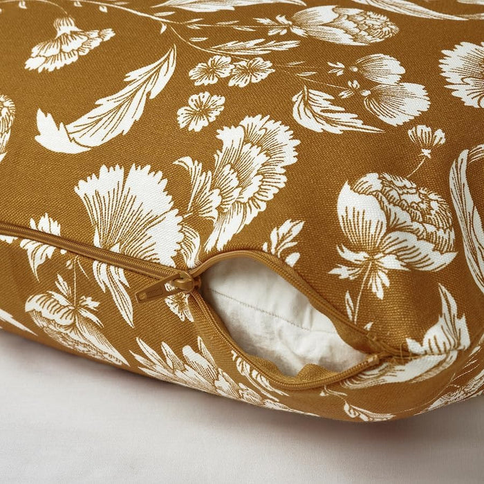 Close-up of yellow-brown cushion cover with white floral design and partially open zipper – 20570990