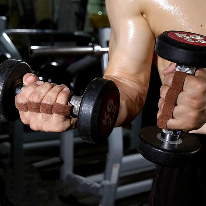 Person holding two dumbbells with a blurred gym background