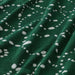 Green fabric with white polka dot pattern