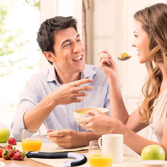 Man and woman sharing a meal together at a table with fruit and drinks.