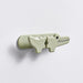 Light green crocodile-shaped hook on a white background