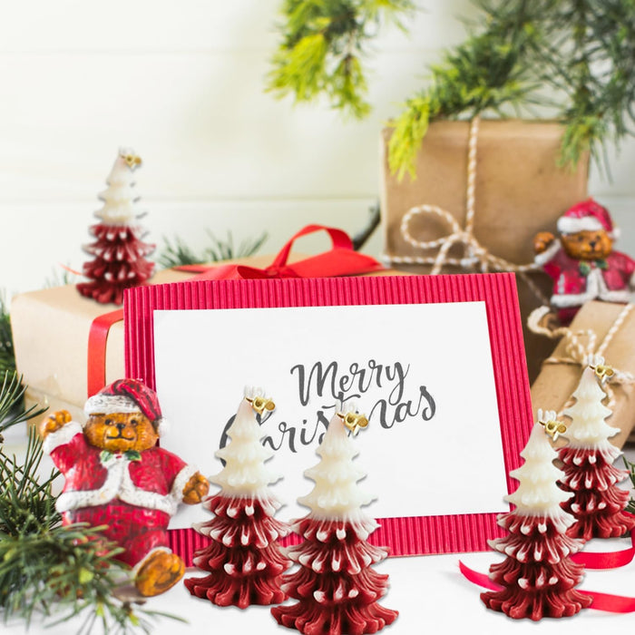 Decorative Christmas trees with a 'Merry Christmas' card and gift boxes.