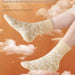 Mango yellow zigzag socks floating in dreamy cloud background with comfort-themed text