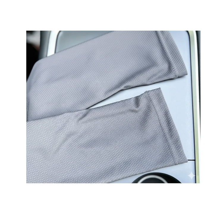Gray sleeves placed on car console, suggesting compact storage and easy access for daily driving routines