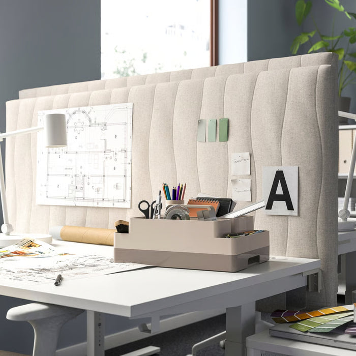 Modern office desk with a whiteboard, stationery items, and a plant in the background.