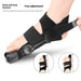 Right foot wearing black valgus orthopedic toe corrector with adjustable angles and hook-and-loop fastener
