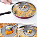 Frying pan with food being lifted out using a strainer and tongs on a white background.