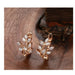 Rose gold wheat earrings – placed on wooden surface showing warm tone and sparkle