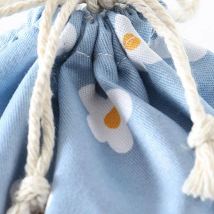 Close-up of blue floral drawstring pouch with thick white cord and textured fabric – 1598445710448 14078092