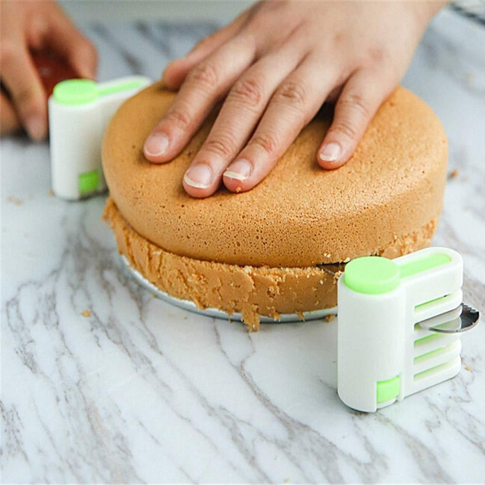 Close-up of cake separator tool slicing a sponge cake into even layers