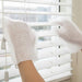 Textured disposable cleaning gloves scrubbing stubborn stains on kitchen counter