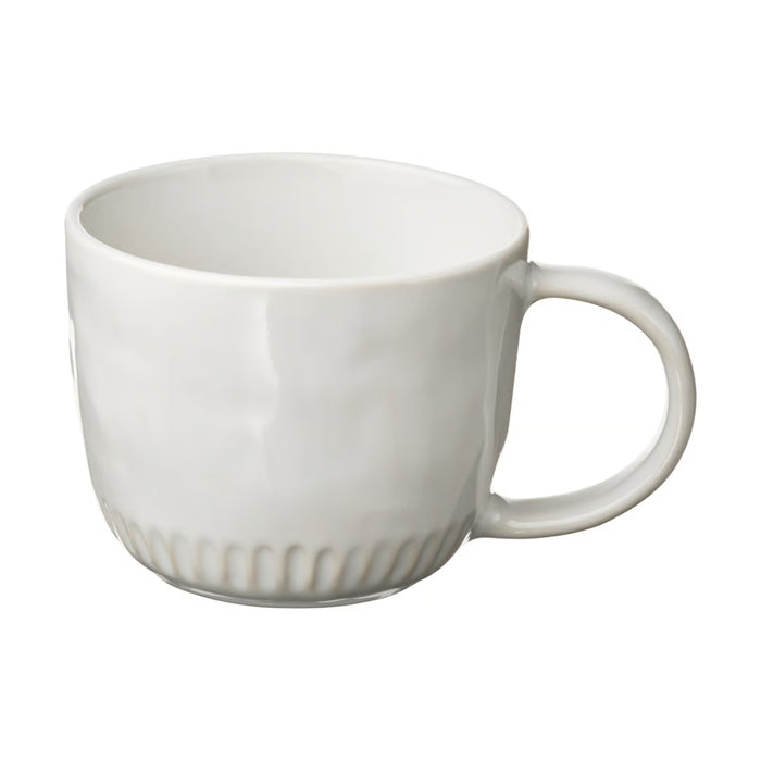 White ceramic mug with a subtle pattern on a white background