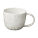 White ceramic mug with a subtle pattern on a white background