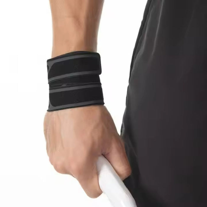 Person wearing the wrist support while holding sports equipment, showcasing its practical use in gym and fitness activities.