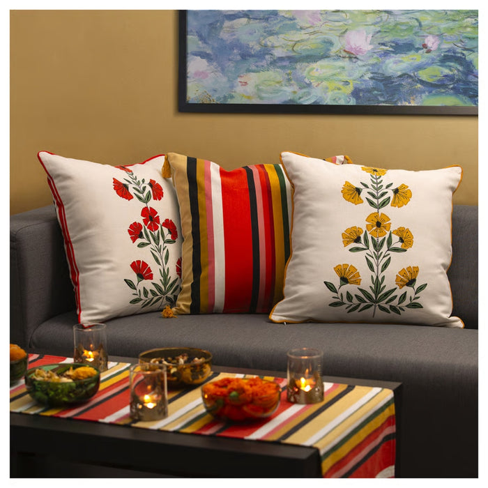 Decorative pillows on a couch with a colorful coffee table in front