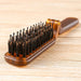 Brown hairbrush with bristles on a wooden surface