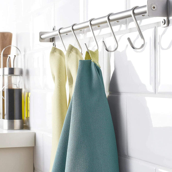 Kitchen towel rack with towels hanging on a kitchen counter.