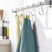 Kitchen towel rack with towels hanging on a kitchen counter.