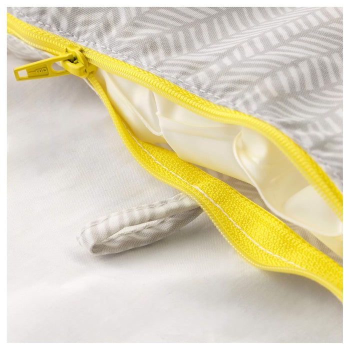 Close-up of a yellow zipper on a gray fabric background