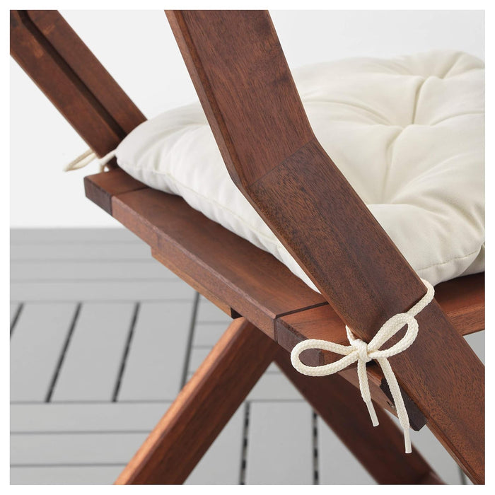 Wooden chair with a white cushion on a wooden deck