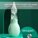 Mint green nasal aspirator with transparent nozzle, promoting calm and healthy breathing for infants
