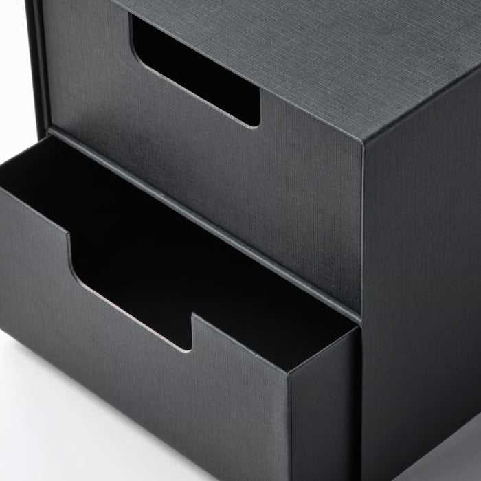 Black metal desk organizer with two compartments on a white background