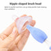 Nipple-shaped brush head with pacifier and cleaning tool on a white background