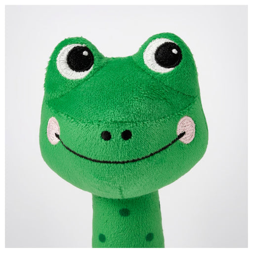 Green plush toy with a smiling face on a white background